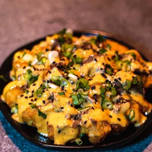 a plate of food with cheese and green onions