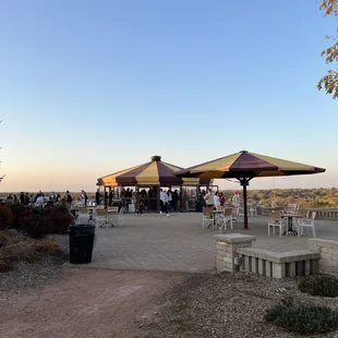 people sitting at tables and umbrellas