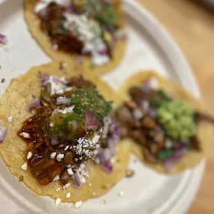 three tacos on a paper plate