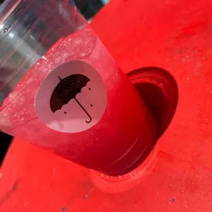 a red table with a red umbrella