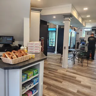 a view of a counter with a basket of bagels on it