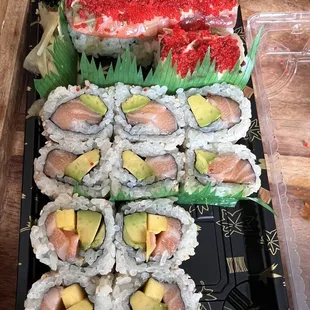 Partly eaten meal, it was so good I couldn't wait - Salmon mango avocado roll, salmon avocado, Christmas roll .