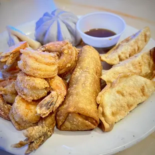 Lightly fried shrimp, soup noodle, egg roll, and fried dumplings.
