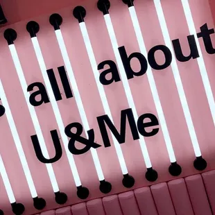 a neon sign that says it's all about u &amp; me