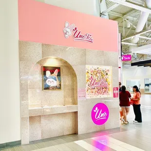 a woman and a man standing in front of a counter