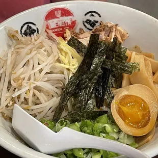 a bowl of food with chopsticks