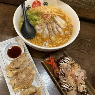 a bowl of ramen and a plate of chicken