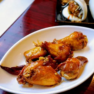 Umi Wings: deep fried wings tossed with vinegar &amp; house mustard sauce and dried red chili peppers ($12).