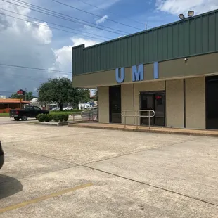 the outside of a building with a car parked in front of it
