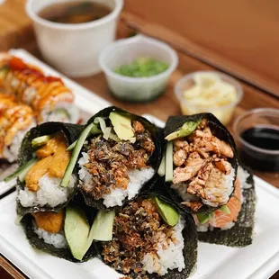 Uni hand roll, truffle salmon skin hand roll, baked salmon hand roll, salmon belly hand roll, and lion king roll in the back!