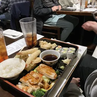 Seaweed salad, chicken dinner bento, spider roll and spicy lobster roll.