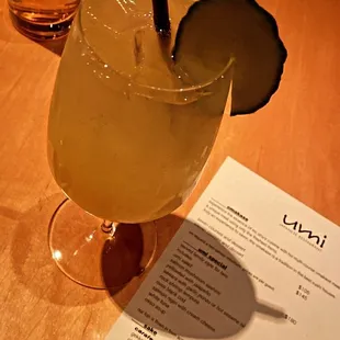 a drink and a menu on a table