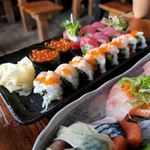 two trays of sushi on a table