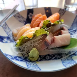 a plate of sushi and vegetables