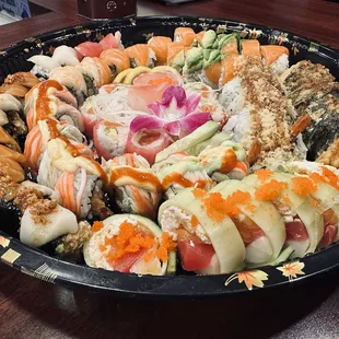 Delicious party tray : yummy roll, amazing roll, rainbow roll, oishi roll, king salmon roll, #2 roll, crunchy roll and cherry blossom roll.