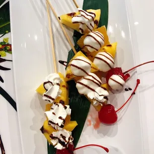 a banana split with whipped cream and cherries