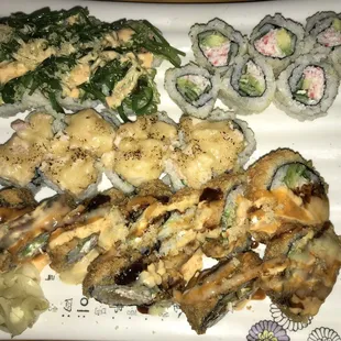 a plate of sushi and rolls