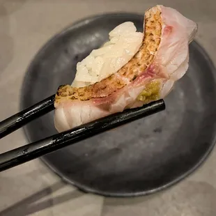 chopsticks holding a piece of food