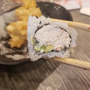 a plate of food with chopsticks