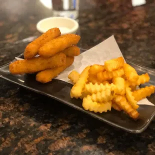 a plate of french fries and onion rings