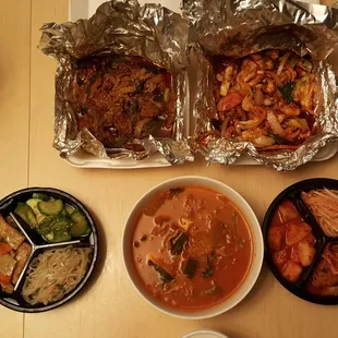 Takeout: marinated spicy sliced pork, spicy squid stir fry, spicy kimchi soup and side dishes