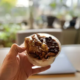 a person holding a bowl of food