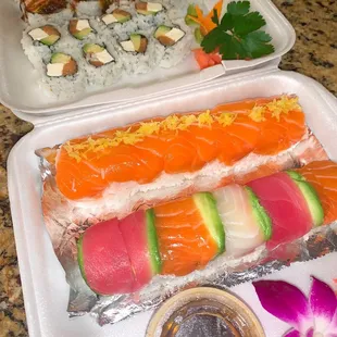 (front) rainbow roll, salmon zest roll, philadelphia roll, and special metairie roll (back)