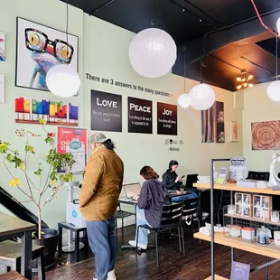 people sitting at tables in a coffee shop