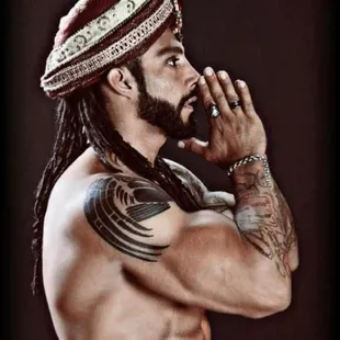 a man with dreads and a hat