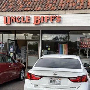 two cars parked in front of the store