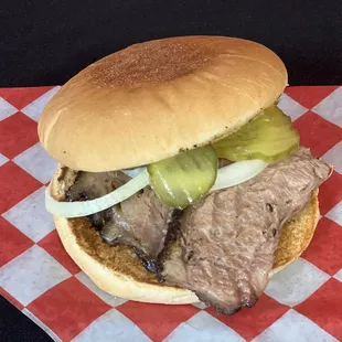 a beef sandwich with pickles