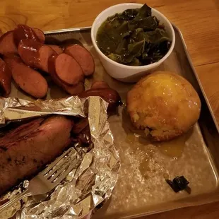 Hot sausage, brisket, greens, coleslaw, and cornbread