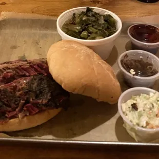 Brisket sandwich, collard greens, Cole slaw and pickle.