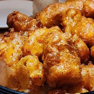 Fried cheese curds made with dyed and undyed cheese