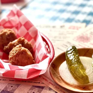 a basket of fried chicken and a pickle