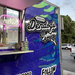 a man standing at a food truck