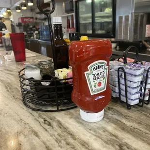 Condiments at the counter. Pie in the back.