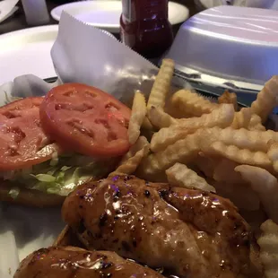 Grilled chicken teriyaki sandwich with fries.