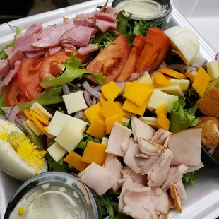 a salad with ham and cheese