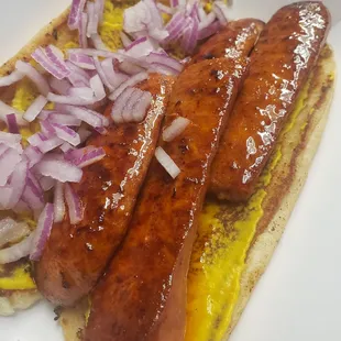 a hot dog with onions and mustard