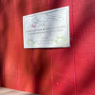 a sign on a red wall