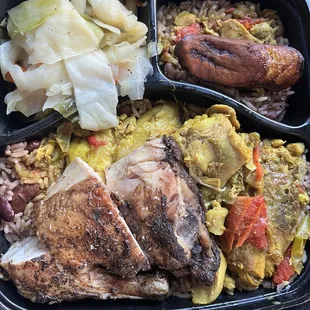 Combo meat jerk chicken and curry chicken, rice and beans, cabbage and a single plantain.