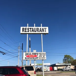 a restaurant sign in a parking lot