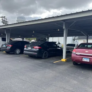 two cars parked under a carportion