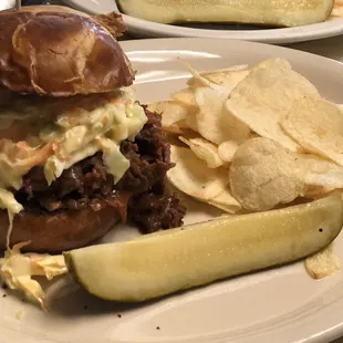 Pulled beef on pretzel bun sandwich