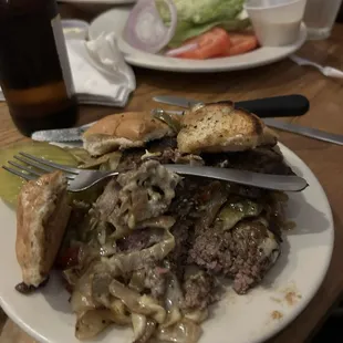 Cheesesteak Cheeseburger. Amazing. Sorry it looks bad. I just cut it up. Wedge salad and a side of grilled onions.