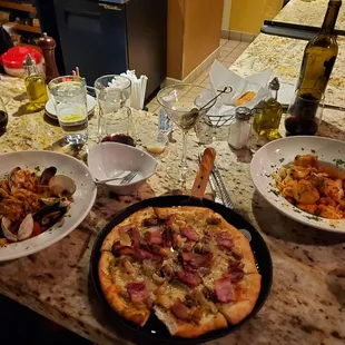 a table full of food and wine