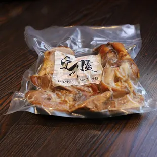 a bag of chicken wings on a wooden table