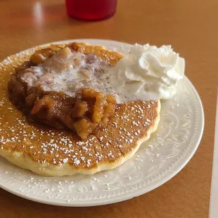 Pancake with apple pie topping and whipped cream
