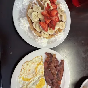 Waffle breakfast - added strawberry and banana  2 eggs over hard and bacon